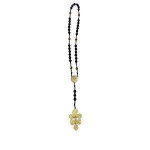 A gold and black beaded necklace with ornate gold medallions and a decorative gold pendant at the end, set against a plain white background.